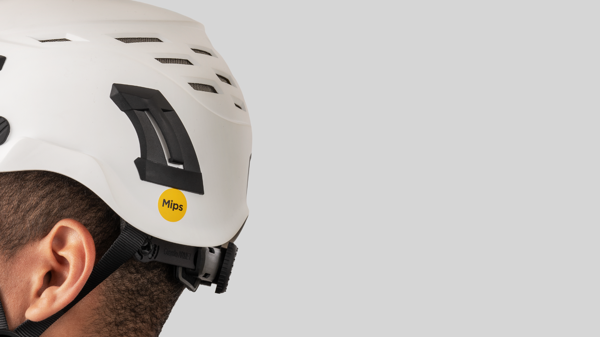 A close-up of a white safety helmet with the Mips logo