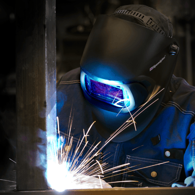 A welder welding while wearing protective equipment from 3M.