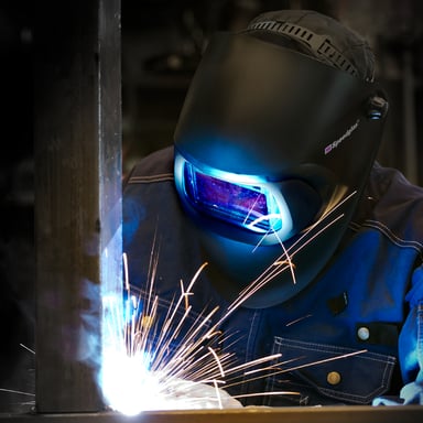 A welder welding while wearing protective equipment from 3M.