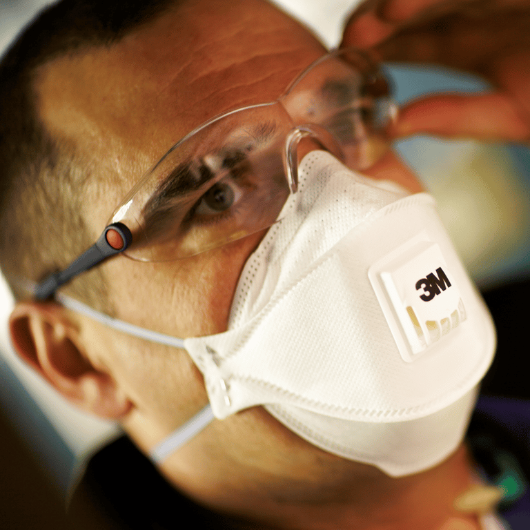 Close Up Of A Male Face With Goggles And Respirator Mask From 3M