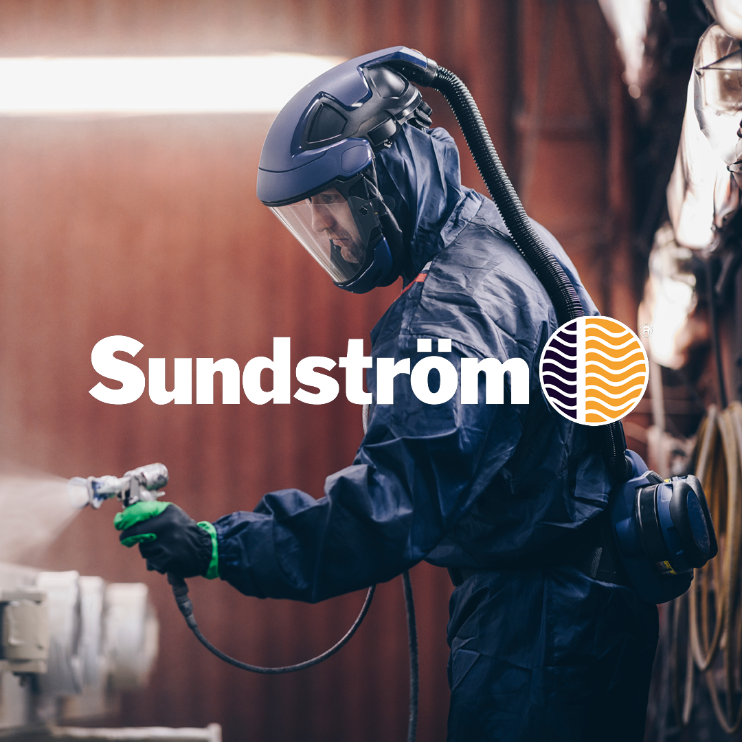 Sundströms logo med et baggrundsbillede af en mand i beskyttelsesdragt og åndedrætsværn med en vifte på ryggen.
