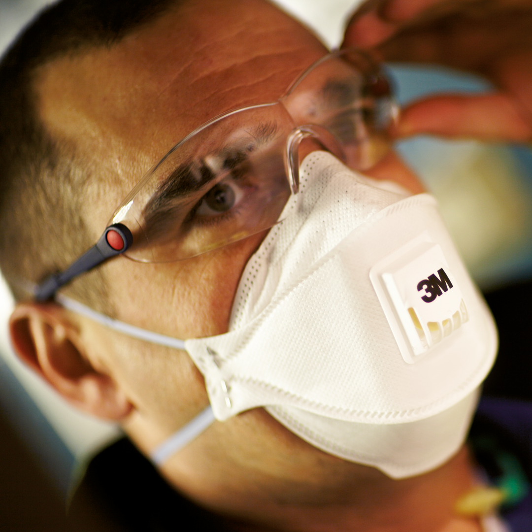 Närbild på ett manligt ansikte med skyddsglasögon och andningsmask från 3M