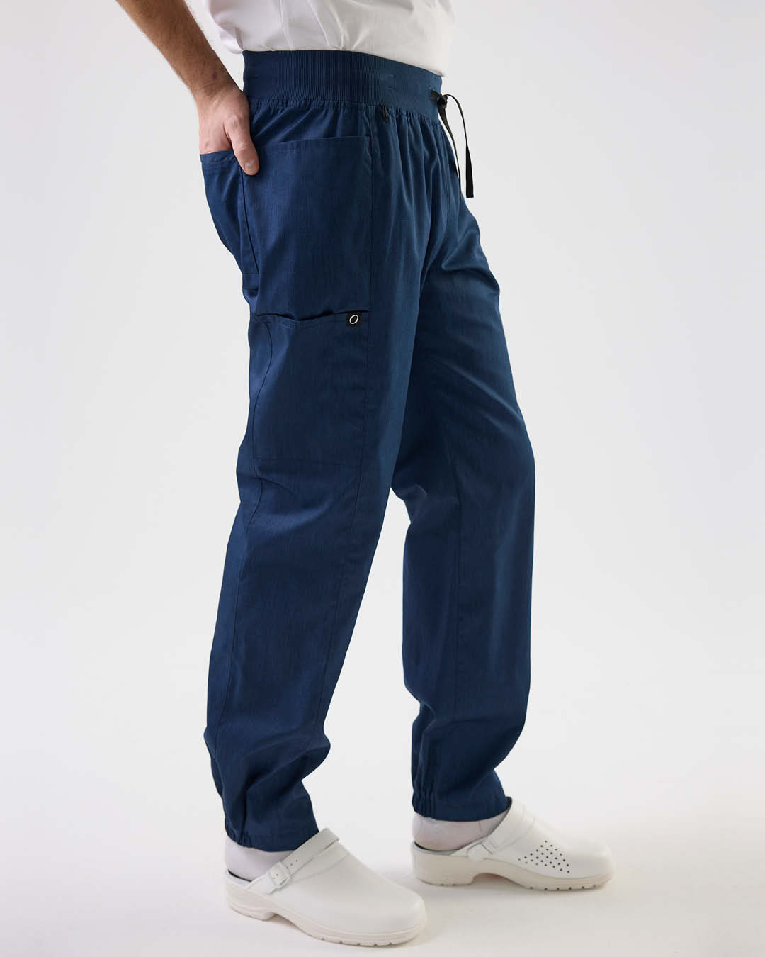 Close-up of legs in grey work trousers from South West – clickable link to category Trousers.