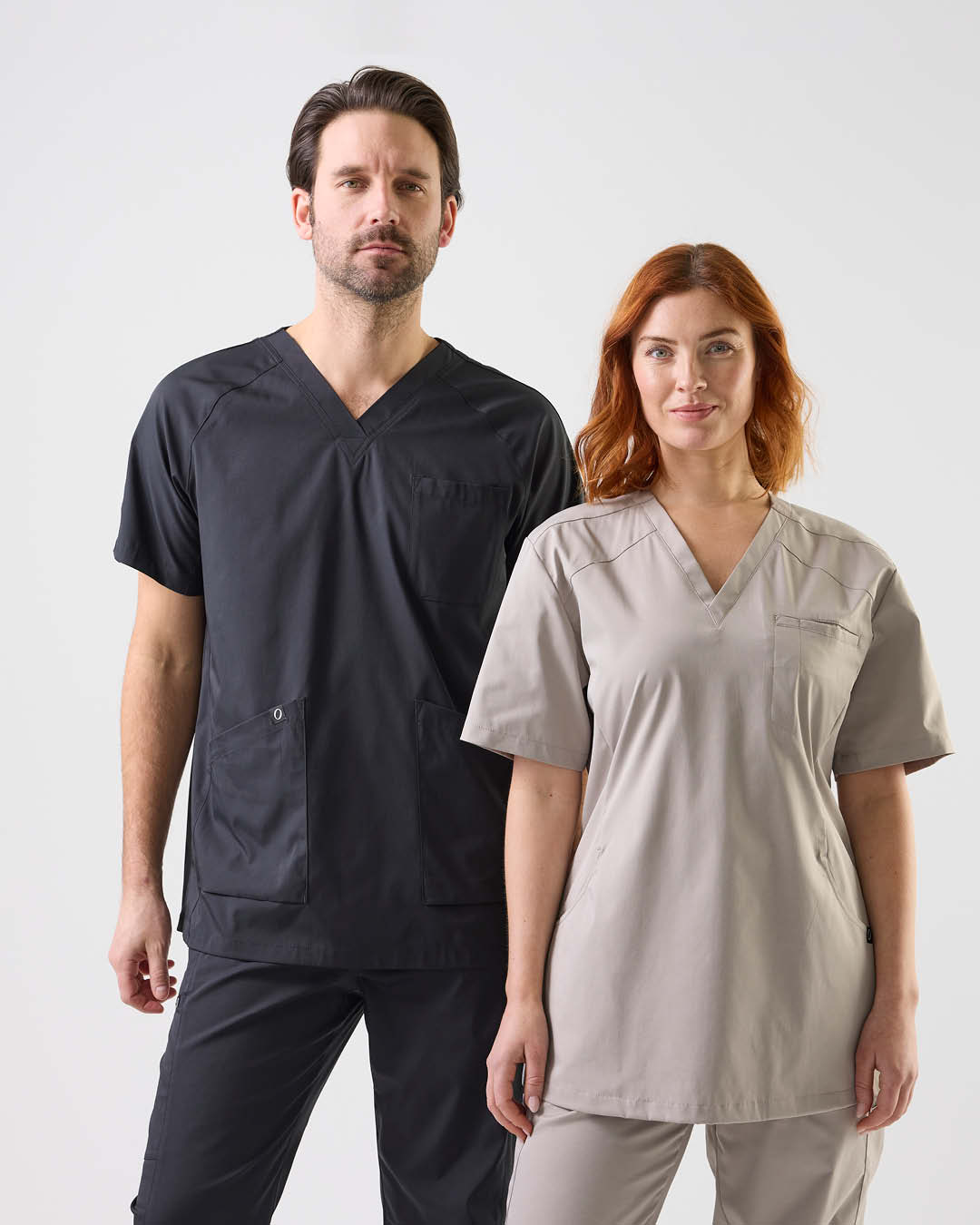 Man and woman in care tunics from South West – clickable link to category Tunics.